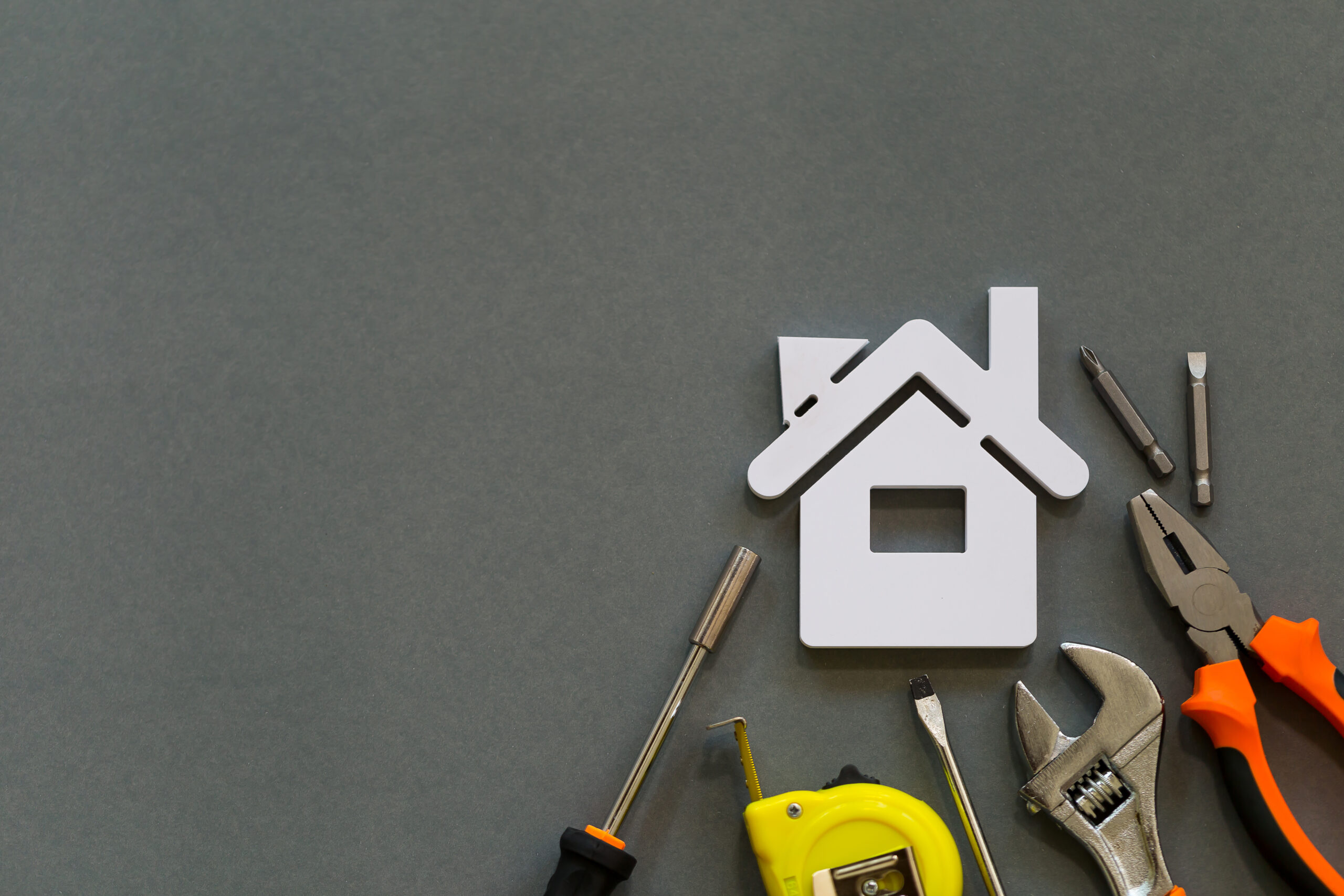 Image of a toy house with tools around it indicating a DIY